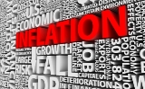 Wall of white letters forming words that have to do with the economy, with the word inflation shown in red letters.